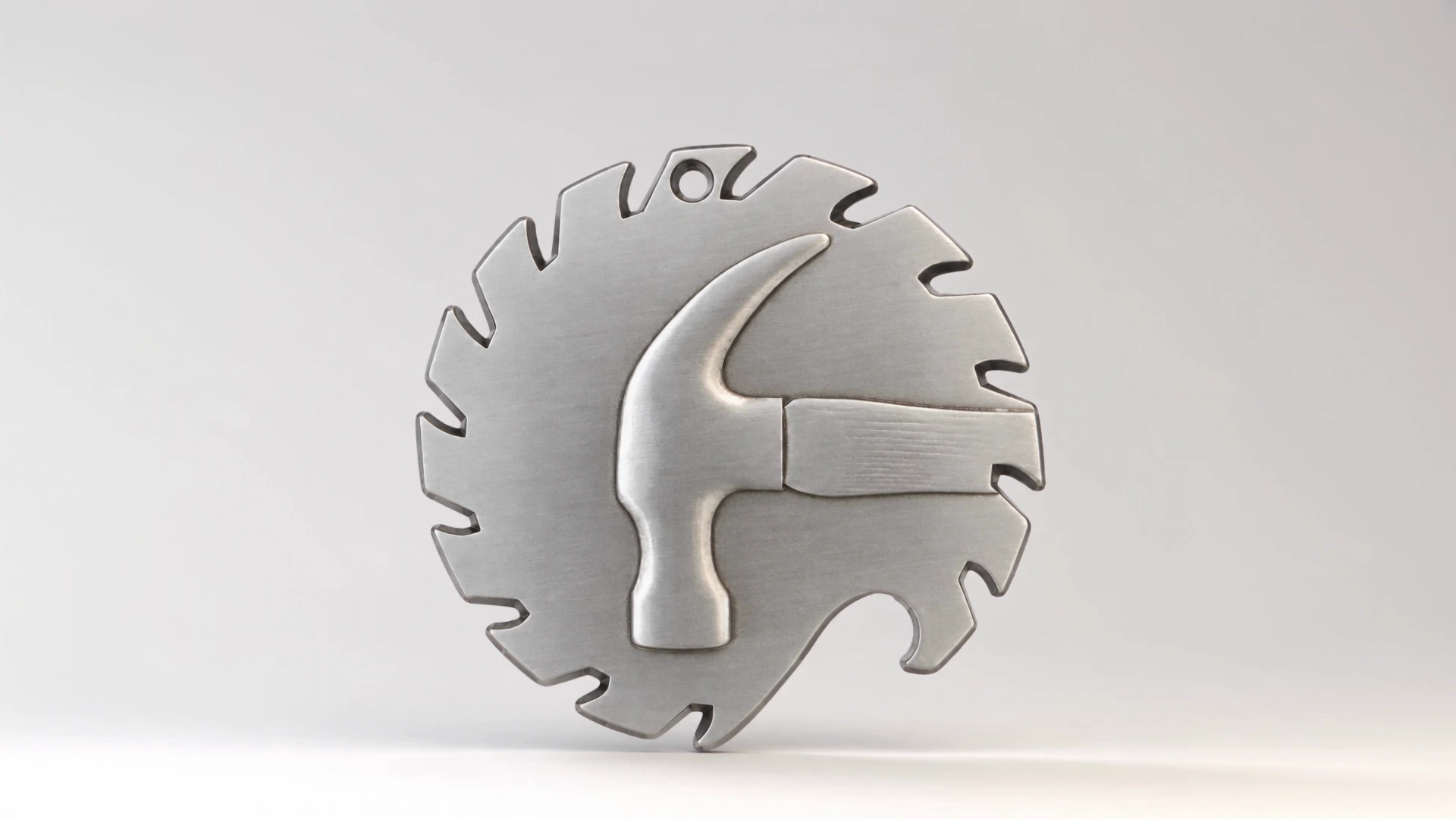 Silver Coppola Brothers challenge coin with saw-blade edging and a raised hammer